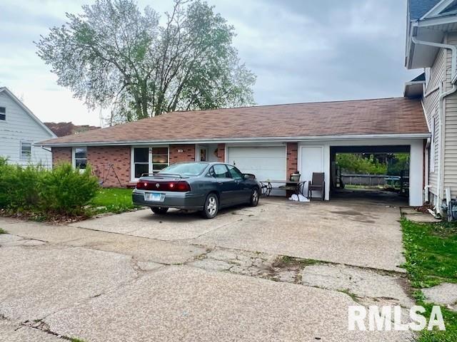 108 Jackson St, Abingdon, IL 61410 - exterior space with an attached garage, brick siding, and driveway