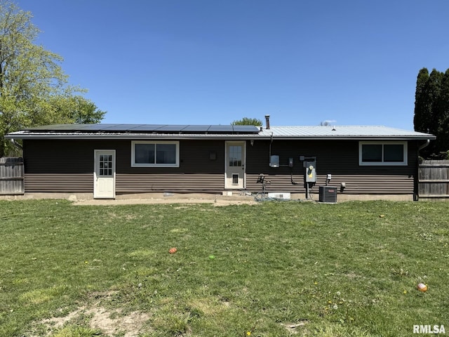 176 Lakeview Dr, Wataga, IL 61488 - back of property featuring roof mounted solar panels, central air condition unit, and entry steps