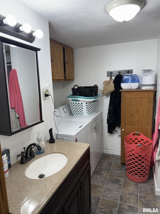176 Lakeview Dr, Wataga, IL 61488 - bathroom featuring separate washer and dryer, stone finish flooring, a textured ceiling, baseboards, and vanity