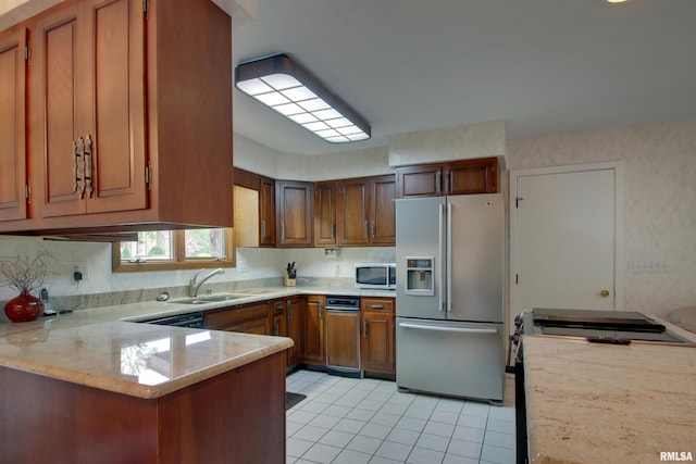 432 W Fairway Dr, Quincy, IL 62305 - kitchen featuring stainless steel appliances, a sink, light tile patterned floors, brown cabinetry, and a peninsula