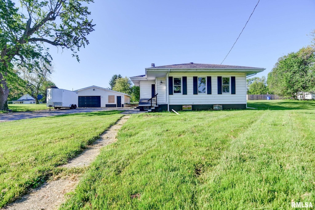 view of front facade featuring a garage, a front lawn, an outdoor structure, and a chimney