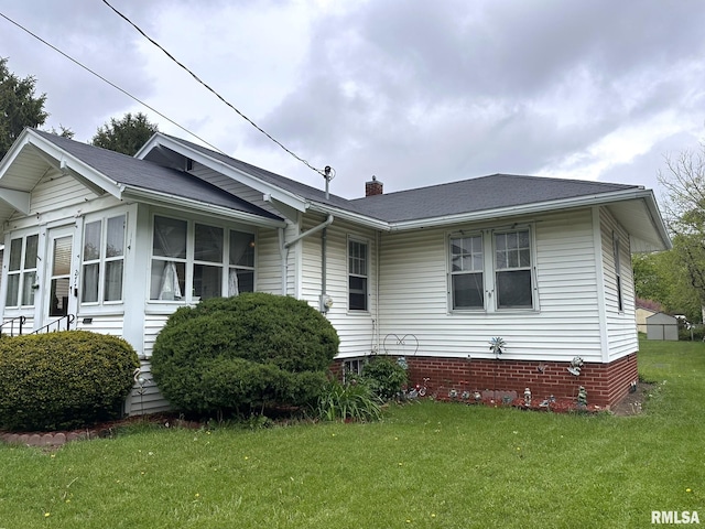 277 N Ivan Ave, Galesburg, IL 61401 - view of front facade with a front lawn, a chimney, and a shingled roof
