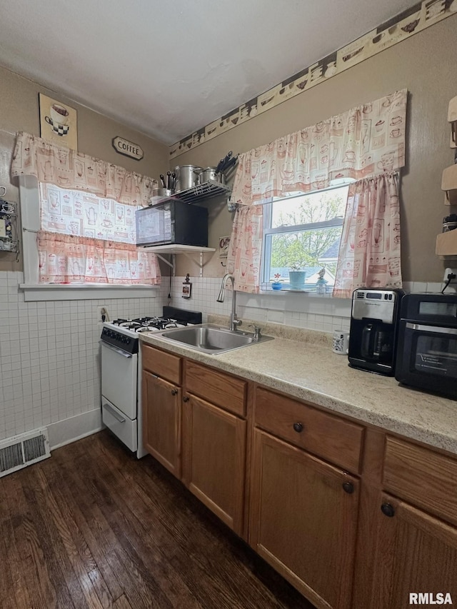 277 N Ivan Ave, Galesburg, IL 61401 - kitchen with white range with gas stovetop, dark wood finished floors, a sink, black microwave, and open shelves