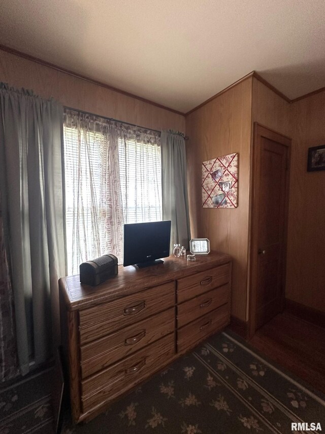 277 N Ivan Ave, Galesburg, IL 61401 - bedroom featuring wooden walls, ornamental molding, and an office area