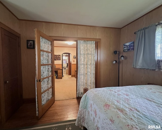 277 N Ivan Ave, Galesburg, IL 61401 - bedroom featuring arched walkways, crown molding, wood walls, and wood finished floors