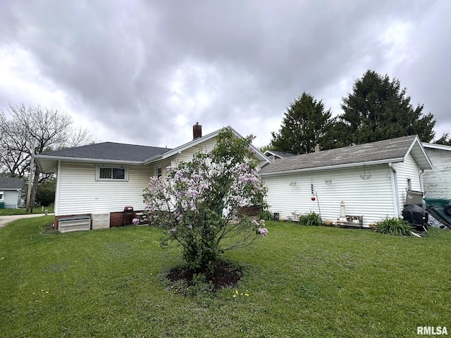 277 N Ivan Ave, Galesburg, IL 61401 - back of property with a chimney, a lawn, and roof with shingles
