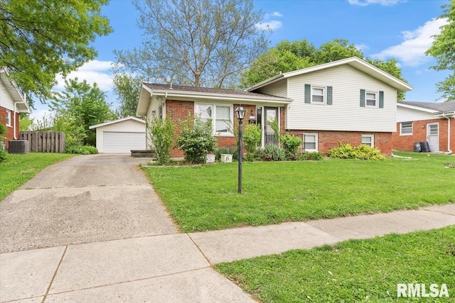 tri-level home featuring brick siding, central AC, an outbuilding, and a detached garage
