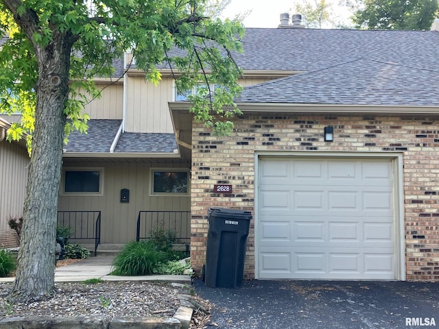 2628 S Forrest Green Dr, Decatur, IL 62521 - view of front of home featuring roof with shingles, brick siding, driveway, and a garage