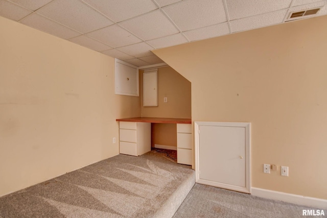 2628 S Forrest Green Dr, Decatur, IL 62521 - basement with a drop ceiling, carpet, built in study area, and electric panel