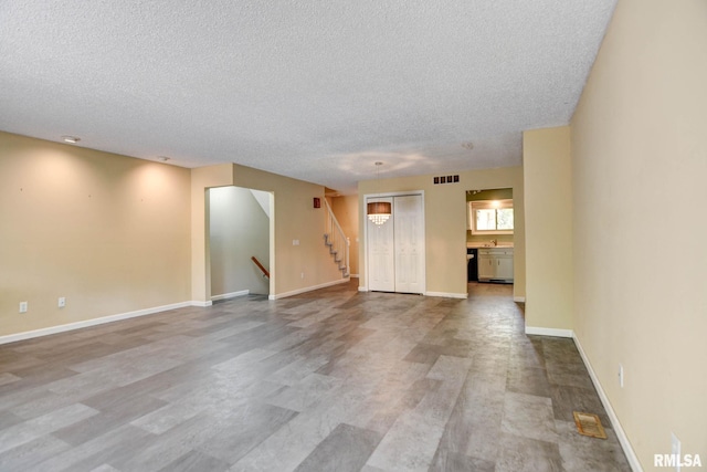 2628 S Forrest Green Dr, Decatur, IL 62521 - unfurnished room featuring a textured ceiling and stairway