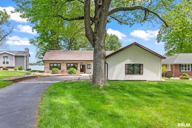 188 E Hazel Dell Ln, Springfield, IL 62712 - view of front of house featuring asphalt driveway, a front lawn, and brick siding