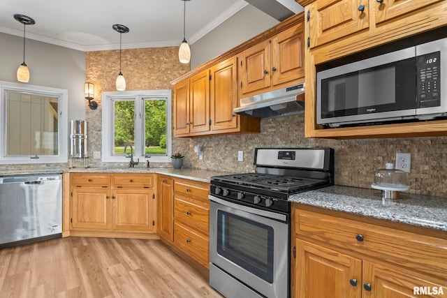 188 E Hazel Dell Ln, Springfield, IL 62712 - kitchen with under cabinet range hood, appliances with stainless steel finishes, light stone counters, decorative backsplash, and crown molding
