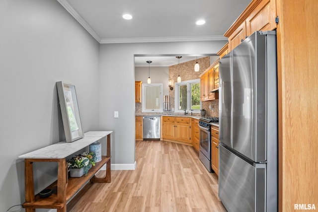 188 E Hazel Dell Ln, Springfield, IL 62712 - kitchen with appliances with stainless steel finishes, light wood-type flooring, decorative backsplash, a sink, and crown molding