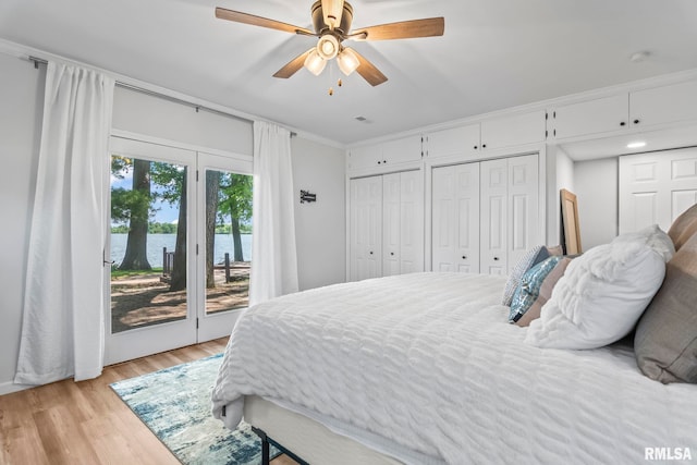 188 E Hazel Dell Ln, Springfield, IL 62712 - bedroom featuring access to outside, a water view, light wood finished floors, multiple closets, and ceiling fan
