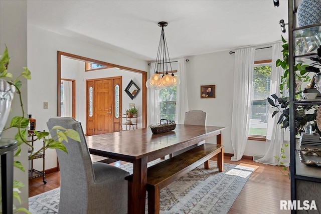 1405 Woods Farm Ln, Springfield, IL 62704 - dining area with healthy amount of natural light, baseboards, light wood-style flooring, and a chandelier