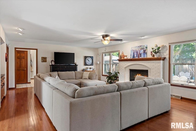 1405 Woods Farm Ln, Springfield, IL 62704 - living area featuring a ceiling fan, hardwood / wood-style flooring, a brick fireplace, and baseboards