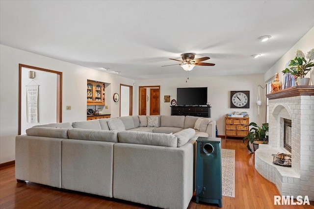 1405 Woods Farm Ln, Springfield, IL 62704 - living area featuring a ceiling fan, wood finished floors, and a brick fireplace
