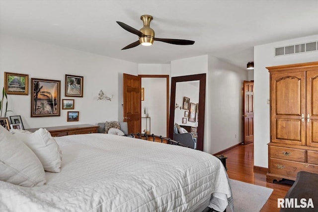 1405 Woods Farm Ln, Springfield, IL 62704 - bedroom with wood finished floors, baseboards, and ceiling fan