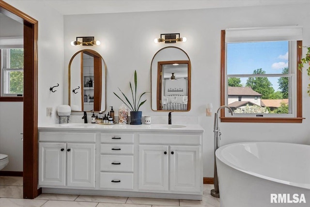 1405 Woods Farm Ln, Springfield, IL 62704 - bathroom with a soaking tub, toilet, double vanity, and tile patterned floors