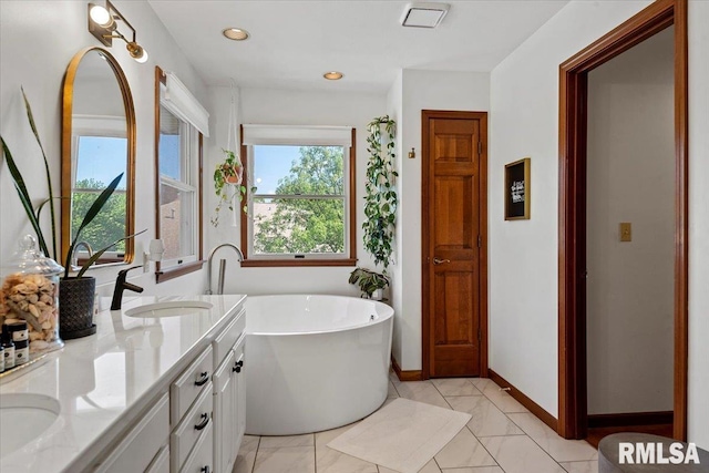 1405 Woods Farm Ln, Springfield, IL 62704 - full bath with a freestanding bath, double vanity, baseboards, marble look tile flooring, and recessed lighting