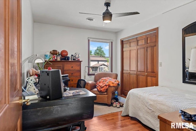 1405 Woods Farm Ln, Springfield, IL 62704 - bedroom with light wood finished floors, a closet, and a ceiling fan