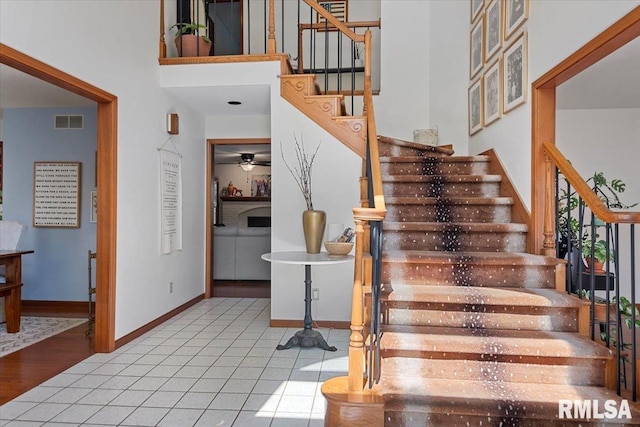 1405 Woods Farm Ln, Springfield, IL 62704 - stairs with baseboards, ceiling fan, and a high ceiling