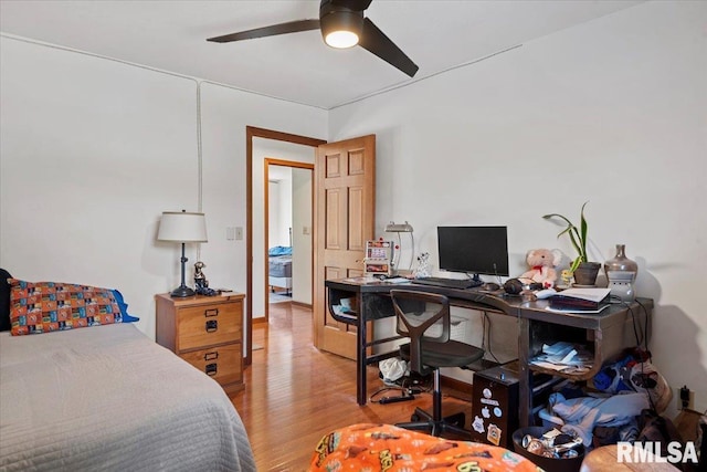 1405 Woods Farm Ln, Springfield, IL 62704 - bedroom with light wood finished floors, a desk, and a ceiling fan