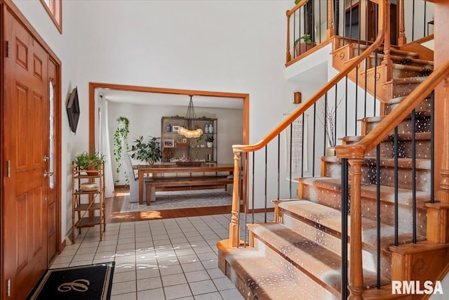1405 Woods Farm Ln, Springfield, IL 62704 - foyer entrance featuring a towering ceiling, tile patterned flooring, a chandelier, and stairs