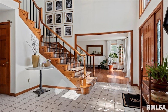 1405 Woods Farm Ln, Springfield, IL 62704 - tiled entryway featuring a towering ceiling, stairway, and baseboards