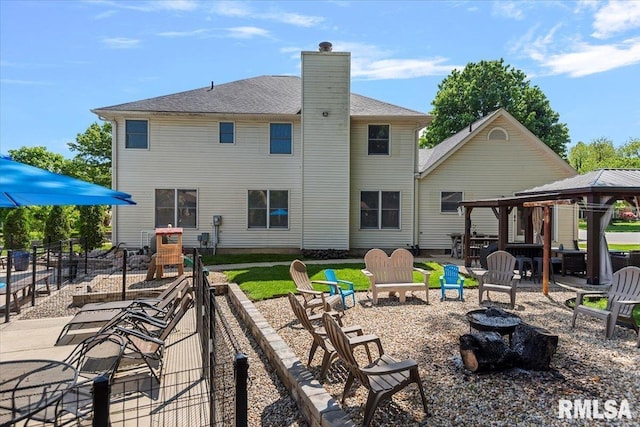1405 Woods Farm Ln, Springfield, IL 62704 - back of property with an outdoor fire pit, a gazebo, a chimney, and a patio
