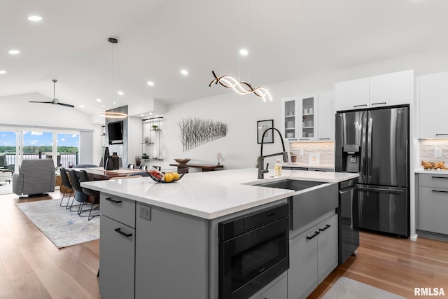 321 Harbor Point Pl, Springfield, IL 62712 - kitchen with stainless steel fridge with ice dispenser, a sink, built in microwave, light countertops, and lofted ceiling
