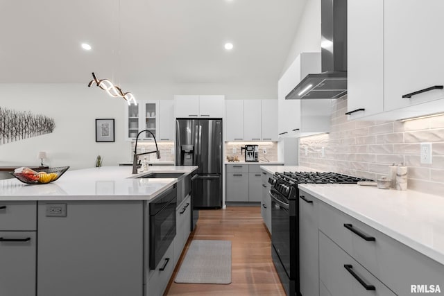 321 Harbor Point Pl, Springfield, IL 62712 - kitchen featuring black gas range, wall chimney exhaust hood, stainless steel refrigerator with ice dispenser, gray cabinets, and a sink