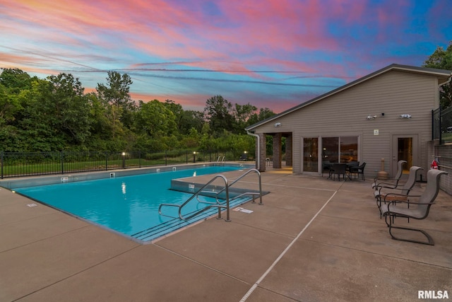 321 Harbor Point Pl, Springfield, IL 62712 - pool at dusk with fence, a patio area, and a community pool