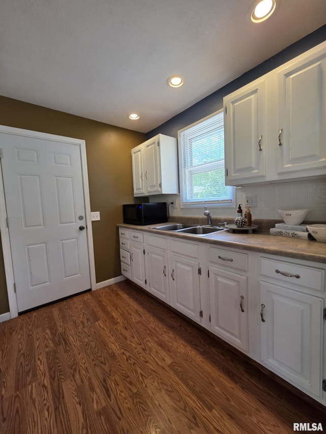 514 W Washington St, Mendon, IL 62351 - kitchen with black microwave, a sink, white cabinets, and recessed lighting
