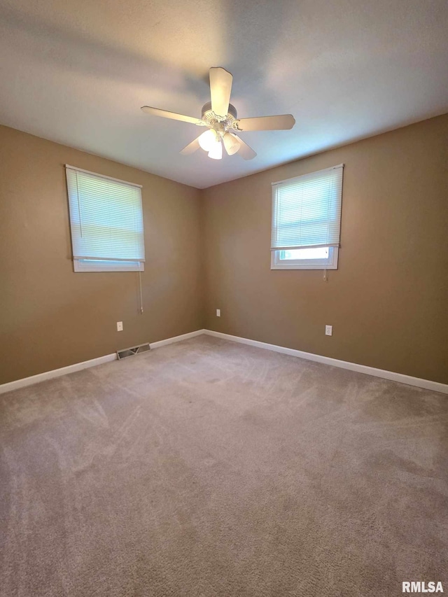 514 W Washington St, Mendon, IL 62351 - unfurnished room featuring a ceiling fan, carpet floors, and baseboards