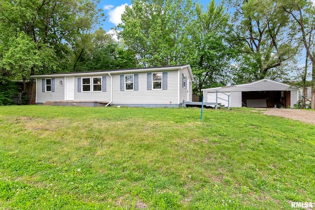 view of front facade with a front yard, a garage, an outdoor structure, and driveway