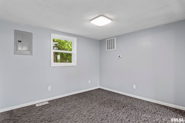 below grade area with electric panel, a textured ceiling, baseboards, and carpet flooring