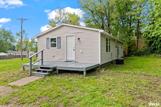 back of house with a wooden deck and central AC unit