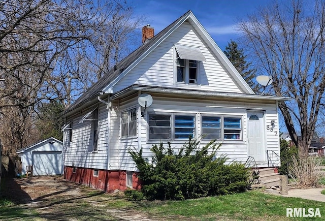 857 E Knox St, Galesburg, IL 61401 - view of front of home with an outbuilding, a chimney, entry steps, a garage, and driveway