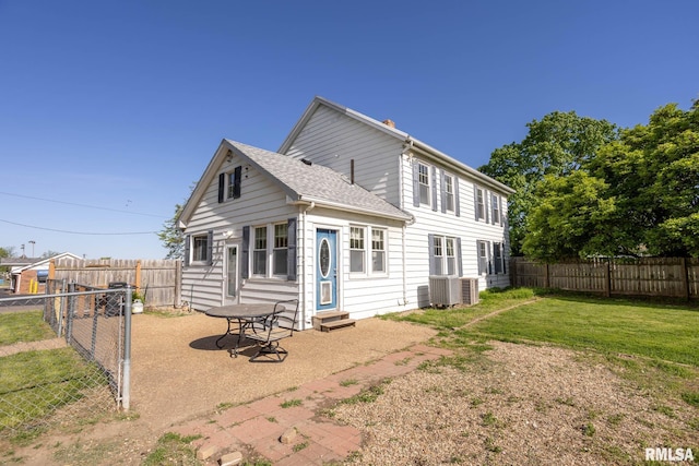 309 W State St, Payson, IL 62360 - back of property with entry steps, roof with shingles, a chimney, and central AC