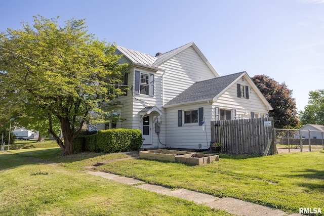 309 W State St, Payson, IL 62360 - traditional home featuring a garden and a shingled roof