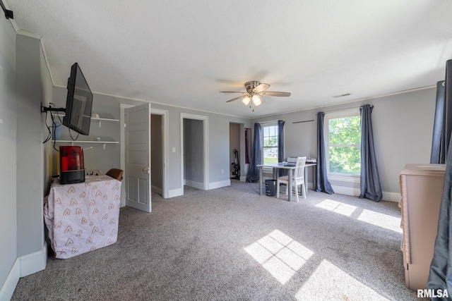 309 W State St, Payson, IL 62360 - living area with carpet floors, a ceiling fan, crown molding, and baseboards