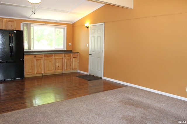 214 W B St, Alpha, IL 61413 - kitchen with freestanding refrigerator, lofted ceiling, dark colored carpet, dark countertops, and baseboards