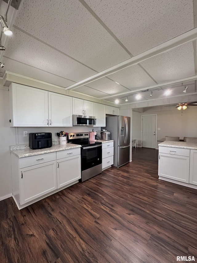 209 Brookview Dr, Abingdon, IL 61410 - kitchen featuring appliances with stainless steel finishes, white cabinetry, dark wood-style flooring, and track lighting