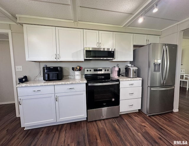 209 Brookview Dr, Abingdon, IL 61410 - kitchen featuring stainless steel appliances, dark wood-style floors, white cabinetry, track lighting, and beam ceiling