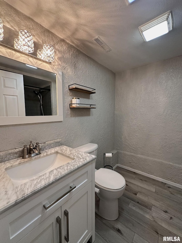 209 Brookview Dr, Abingdon, IL 61410 - bathroom with a textured wall, wood finished floors, a textured ceiling, vanity, and toilet