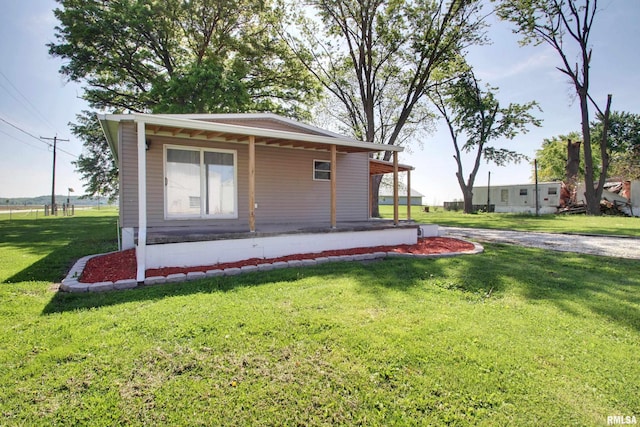 view of property exterior with a lawn and covered porch