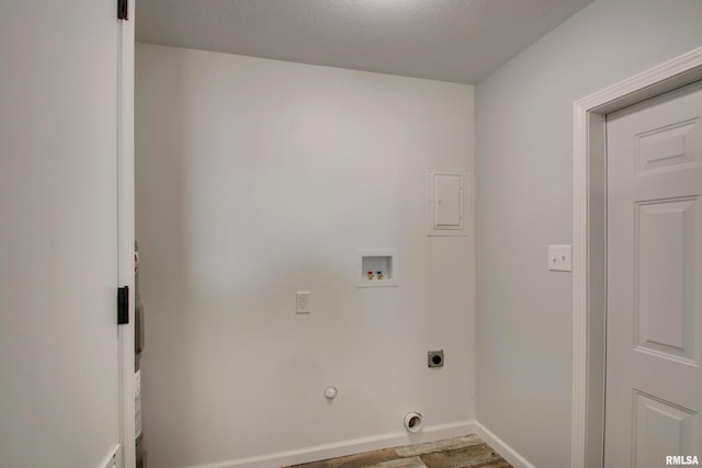 laundry room with hookup for a washing machine, electric dryer hookup, wood finished floors, baseboards, and hookup for a gas dryer