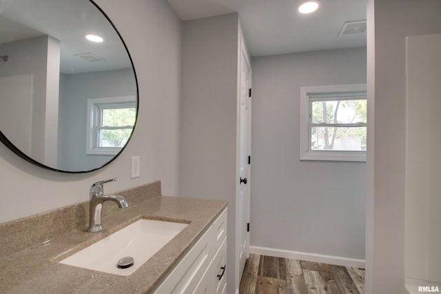 bathroom featuring wood finished floors, vanity, recessed lighting, and baseboards