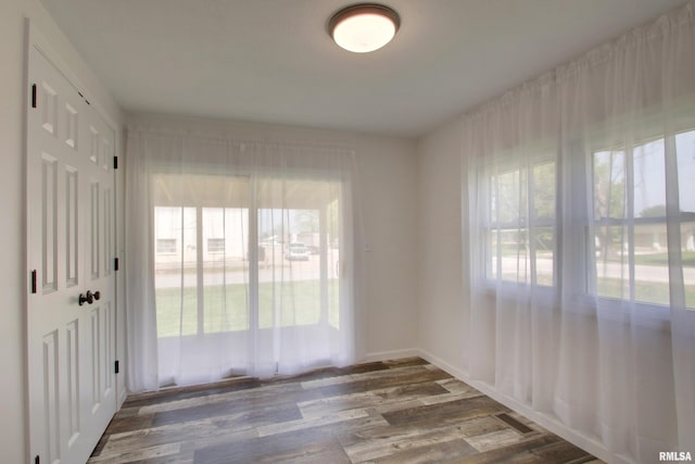 unfurnished room with wood finished floors